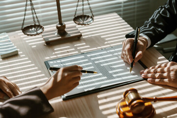 Lawyers are reviewing and signing important documents for a client in their law office