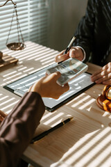 Businessman is bribing a lawyer with a stack of money in an office, with a scale of justice and a gavel on the desk