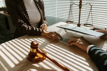 Lawyer is accepting a bribe from a client in their office, with a gavel and scales of justice in the foreground