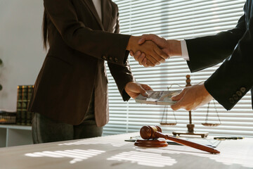 Businesswoman bribes a lawyer with money in an office, showing corruption and illegal dealings. The...