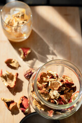 Preparation of fly agaric drink, ground powdered dry mushroom on ice cubes in a glass, illuminated by natural sunlight.  Homemade fly agaric elixir. Top View