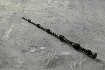 One magic wand on grey textured table