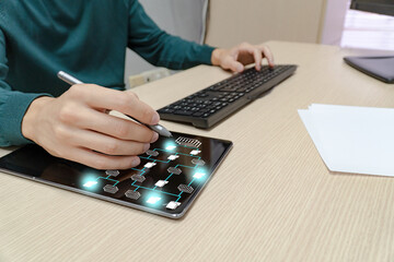 Side view of a business man using a tablet in the office with a pen, some digital graphics with folders, online work concept