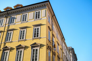 Facades of Italian buildings with colorful walls in the sun.