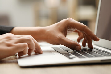Businessman using laptop at table, closeup. Modern technology