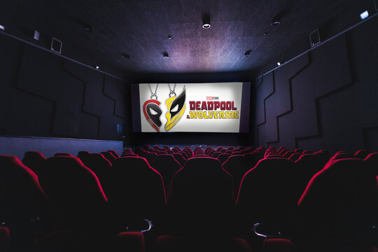 Deadpool and Wolverine action movie on empty Cinema theater, big projection screen showing popular movie