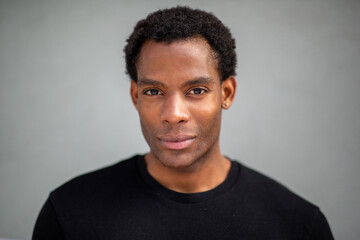 Man looking directly at camera on gray background