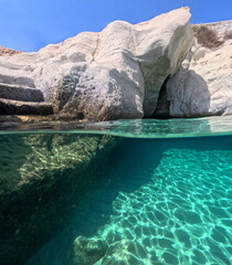 Underwater split photo of paradise exotic island rocky bay with crystal clear turquoise sea in Caribbean destination island