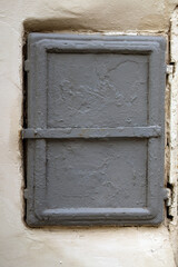 ancient metal door embedded in a wall, serving as a control panel for electricity. Its weathered texture and historic charm evoke a sense of nostalgia and mystery.