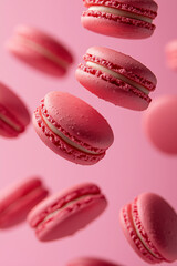 Obraz premium Macarons floating in the air, red pink colors, close-up, light pink background, food photography