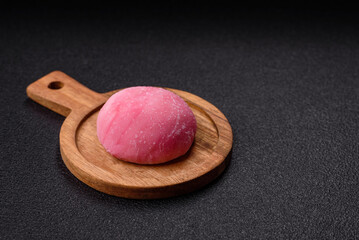 Delicious colorful asian mochi sweets with rice dough shell and fruit filling