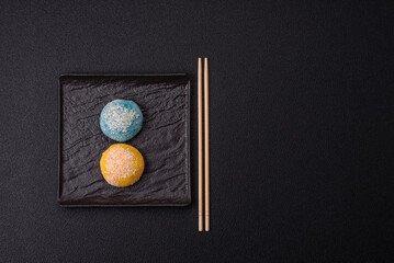Delicious colorful asian mochi sweets with rice dough shell and fruit filling