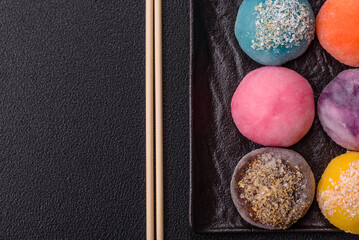 Delicious colorful asian mochi sweets with rice dough shell and fruit filling