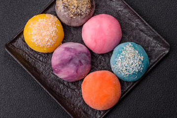 Delicious colorful asian mochi sweets with rice dough shell and fruit filling