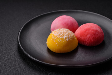 Delicious colorful asian mochi sweets with rice dough shell and fruit filling