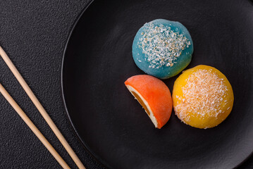 Delicious colorful asian mochi sweets with rice dough shell and fruit filling