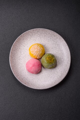 Delicious colorful asian mochi sweets with rice dough shell and fruit filling