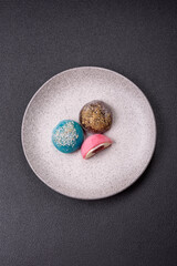 Delicious colorful asian mochi sweets with rice dough shell and fruit filling