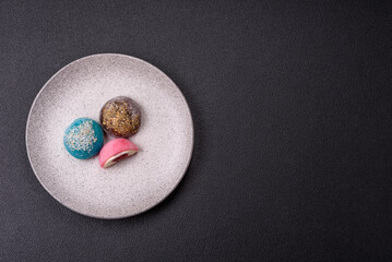 Delicious colorful asian mochi sweets with rice dough shell and fruit filling