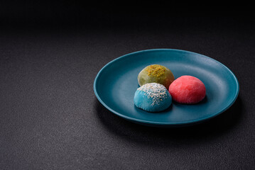 Delicious colorful asian mochi sweets with rice dough shell and fruit filling