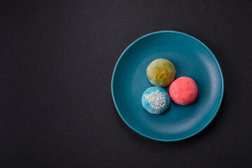Delicious colorful asian mochi sweets with rice dough shell and fruit filling