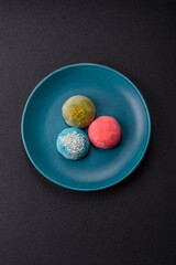 Delicious colorful asian mochi sweets with rice dough shell and fruit filling