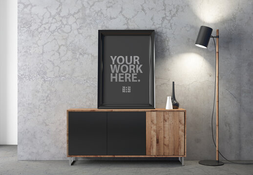 Vertical poster with black frame mockup standing on standing on the chest of drawers