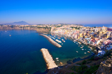 view of Procida island colorful town with small harbour from above, Italy, web banner format