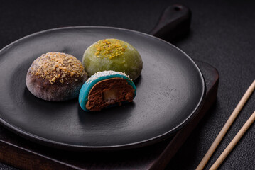 Delicious colorful asian mochi sweets with rice dough shell and fruit filling