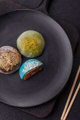 Delicious colorful asian mochi sweets with rice dough shell and fruit filling