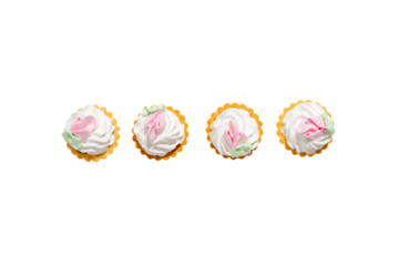 Four small pastries with pink frosting and flowers on top. The pastries are arranged in a row on a white background. Dessert on transparent background PNG.