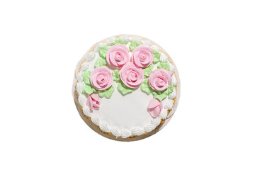 A cake with pink frosting and white frosting with roses on it. The cake is round and has a white...
