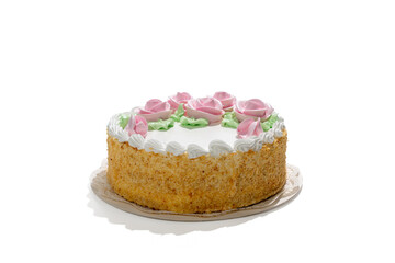 A cake with pink frosting and green leaves on top. The cake is on a white plate. Dessert on transparent background PNG.