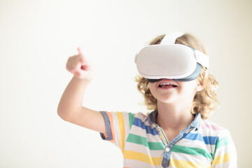 Child in virtual reality goggles. VR set for kids.