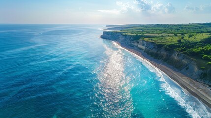 Fototapeta premium Aerial view of a stunning Mediterranean beach. The blue sea glistens under the sun, waves gently breaking on the shore. A serene and beautiful scene