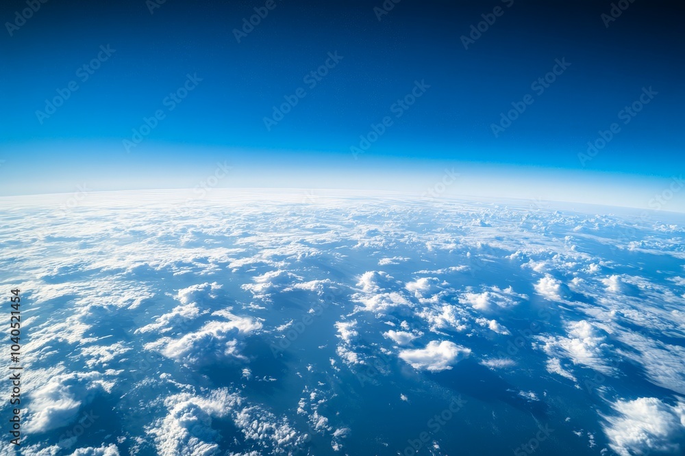 Poster a mesmerizing image of the sky shows scattered fluffy clouds over a deep blue expanse, showcasing th