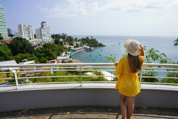 Beautiful fashion girl enjoying view from lookout of All Saints Bay in Salvador de Bahia, Brazil
