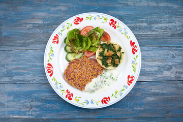 meat with mashed potato and salad