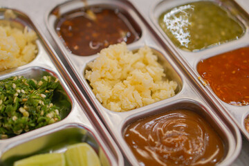 A set of various dipping sauces. A bowl for various dipping sauces. A set of various dipping sauces in various colors.