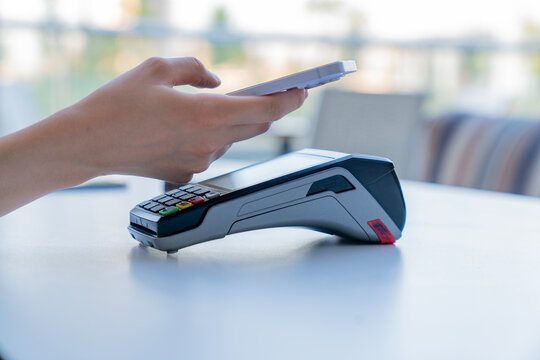 A person is using a credit card reader to pay for something