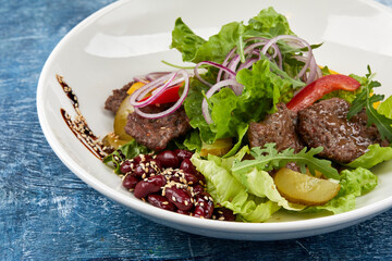 fresh salad with beef and sauce
