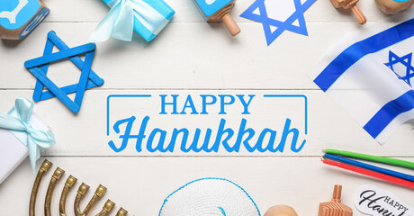 Festive frame made from Hanukkah symbols on white wooden background