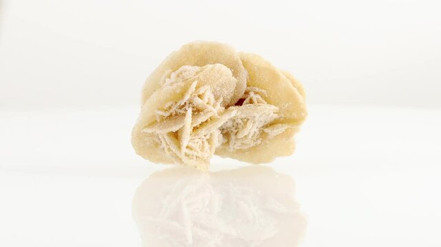 Desert roses mineral stone spinning in a circle on a white background