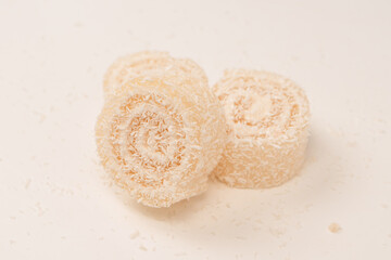 Coconut candy roll isolated on a white background.