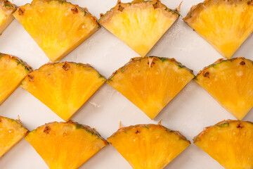 Pineapple juicy yellow slices on a white background.
