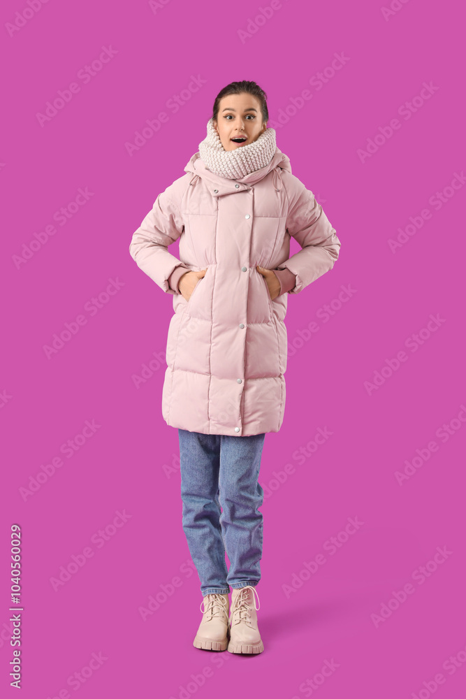 Canvas Prints Young woman in down coat on purple background