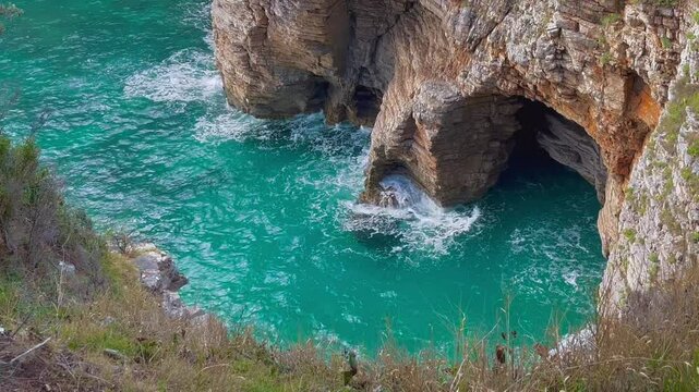 Stunning Turquoise Sea Cave with Rocky Cliffs at Uvala Na Ploču, Budva, Montenegro, Captured from a High Angle Showing Natural Water Flow and Stone Formations