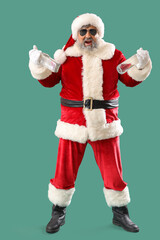 Bad Santa Claus with bottles of vodka on green background
