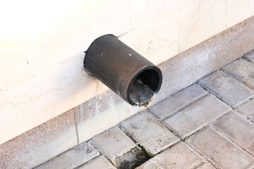 Drainage pipe for waste water disposal in the wall of a building, close-up