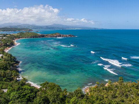 Surfers enjoying Entre-deux surf spot at Anse l'Etang beach, Tartane, Martinique, West Indies, France